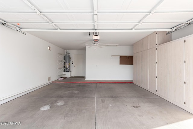 garage with a garage door opener and gas water heater