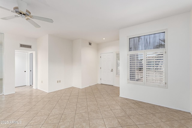 empty room with light tile patterned flooring and ceiling fan