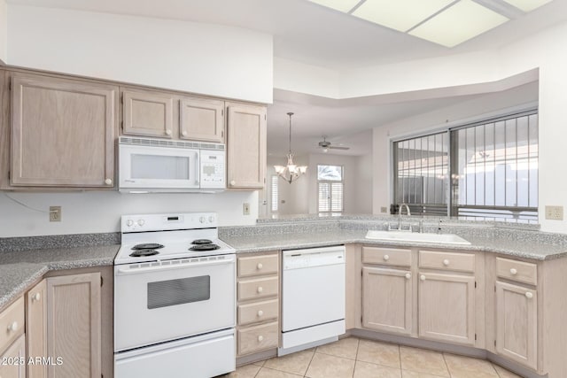 kitchen with light brown cabinetry, sink, white appliances, and light tile patterned floors