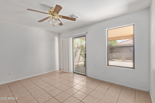 2421 W Romley Rd, Phoenix, AZ 85041 - unfurnished room featuring light tile patterned flooring, ceiling fan, and baseboards