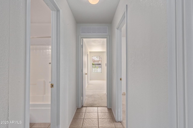 2421 W Romley Rd, Phoenix, AZ 85041 - corridor with a textured wall, light colored carpet, and light tile patterned floors