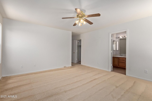 2421 W Romley Rd, Phoenix, AZ 85041 - unfurnished bedroom featuring light colored carpet, ensuite bath, baseboards, and a sink