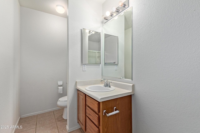 2421 W Romley Rd, Phoenix, AZ 85041 - bathroom featuring toilet, vanity, tile patterned floors, and baseboards