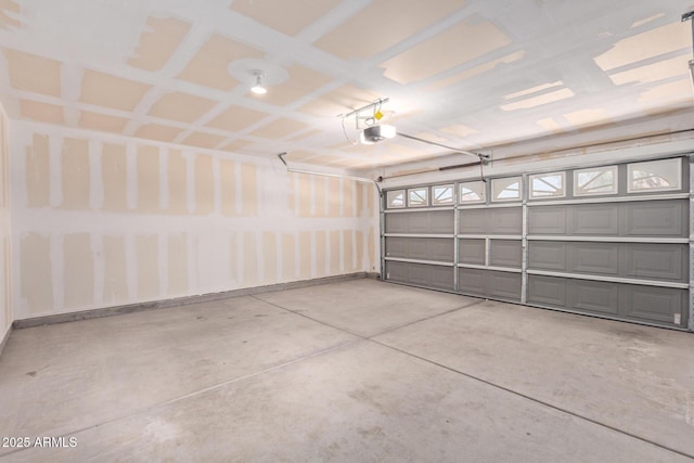 2421 W Romley Rd, Phoenix, AZ 85041 - garage with a garage door opener and baseboards