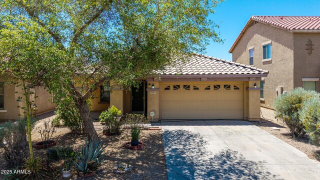 2421 W Romley Rd, Phoenix, AZ 85041 - view of front of property featuring a tiled roof, stucco siding, concrete driveway, and a garage