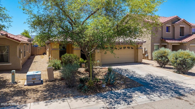 2421 W Romley Rd, Phoenix, AZ 85041 - view of front of property featuring stucco siding, driveway, a tiled roof, and a garage