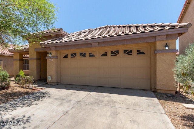 2421 W Romley Rd, Phoenix, AZ 85041 - view of front of property featuring concrete driveway, stucco siding, and an attached garage
