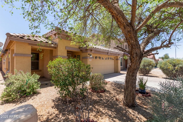 2421 W Romley Rd, Phoenix, AZ 85041 - view of front of home with stucco siding, an attached garage, a tile roof, and driveway