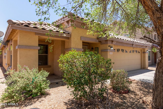 2421 W Romley Rd, Phoenix, AZ 85041 - view of front of house featuring stucco siding, a tile roof, driveway, and an attached garage