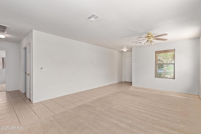 2421 W Romley Rd, Phoenix, AZ 85041 - empty room with light tile patterned floors, a ceiling fan, and light colored carpet