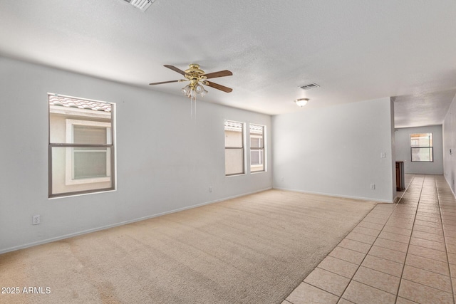 2421 W Romley Rd, Phoenix, AZ 85041 - unfurnished room with a ceiling fan, healthy amount of natural light, light tile patterned floors, and light carpet