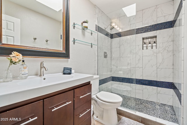 full bathroom featuring a stall shower, toilet, and vanity