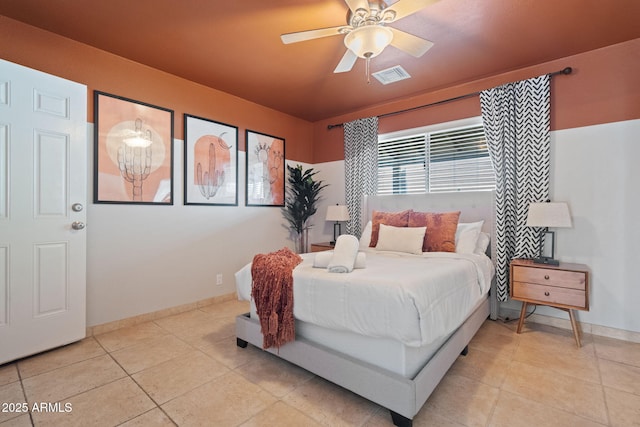 bedroom featuring light tile patterned floors, visible vents, ceiling fan, and baseboards