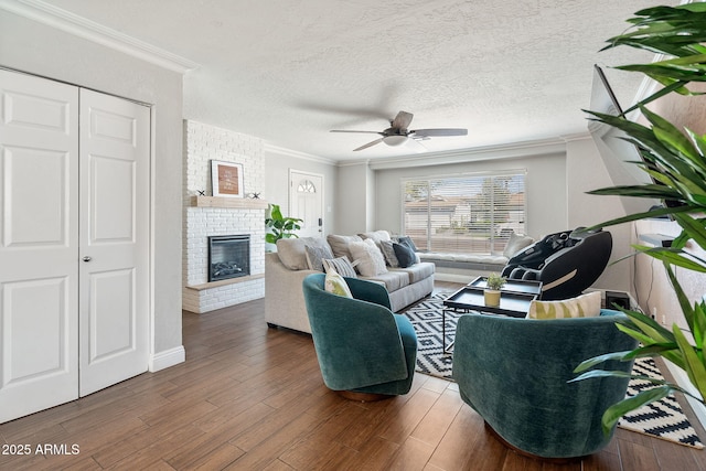 living room with a fireplace, wood finished floors, and crown molding