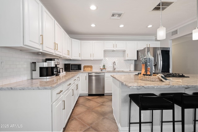 kitchen with visible vents, white cabinets, and stainless steel appliances