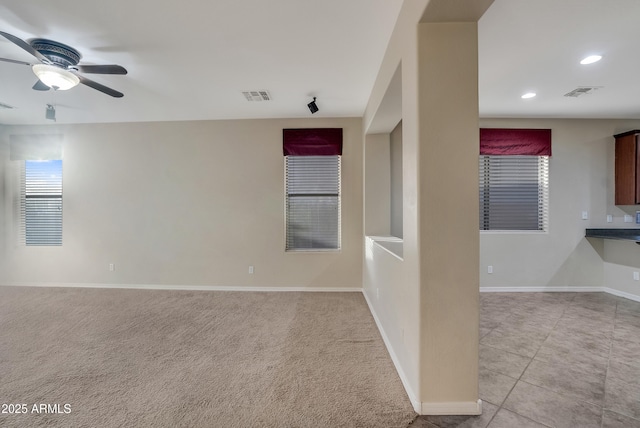 spare room with light tile patterned floors and ceiling fan