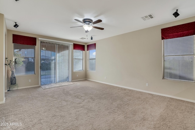 carpeted empty room featuring ceiling fan