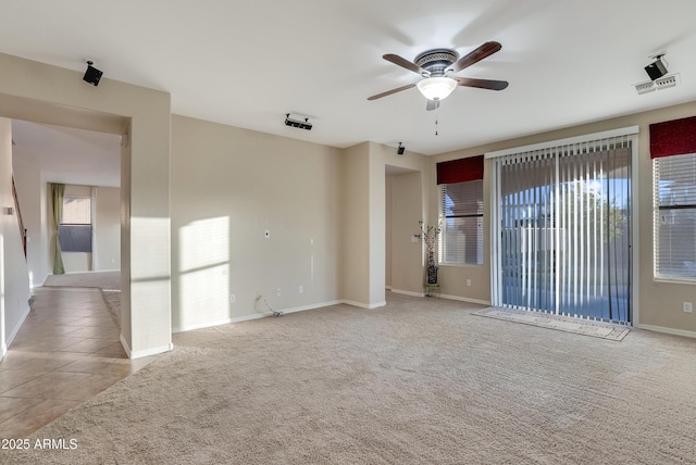 carpeted empty room featuring ceiling fan