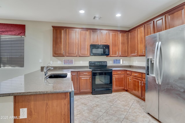 kitchen featuring sink, light stone counters, black appliances, light tile patterned flooring, and kitchen peninsula