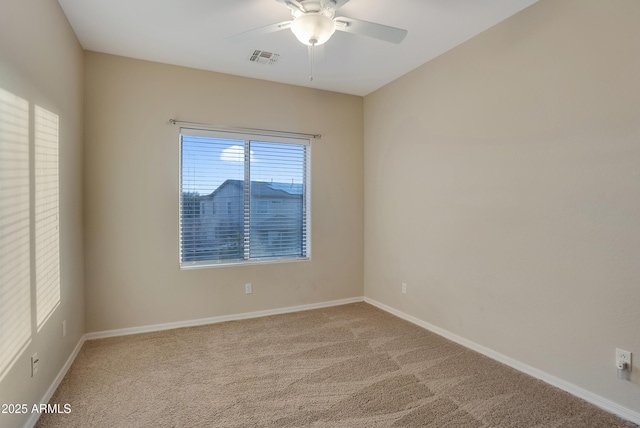 empty room with ceiling fan and carpet floors