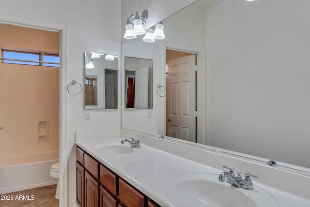 bathroom featuring vanity, tile patterned floors, and toilet