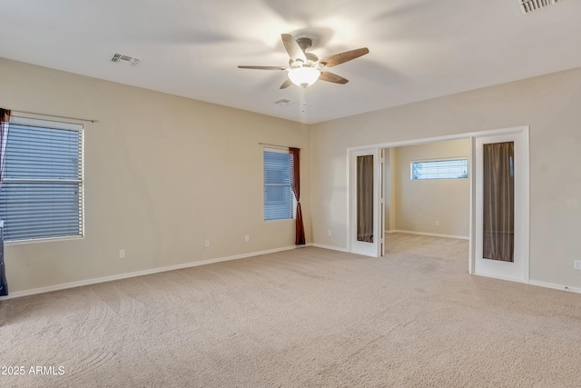 carpeted empty room with ceiling fan