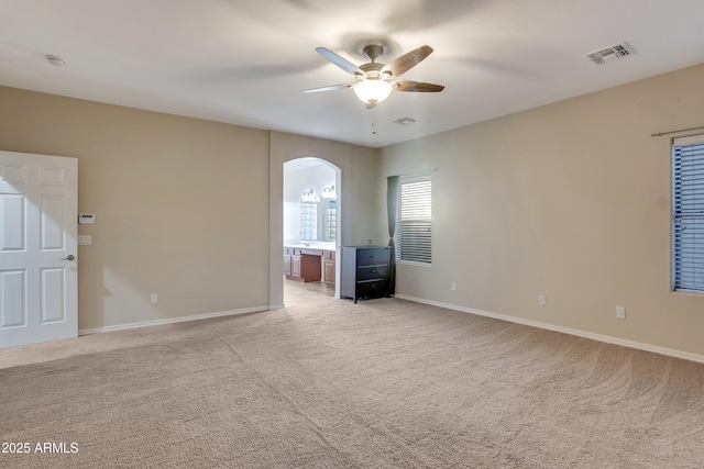 unfurnished room with ceiling fan and light carpet