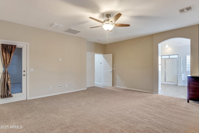 carpeted spare room featuring ceiling fan