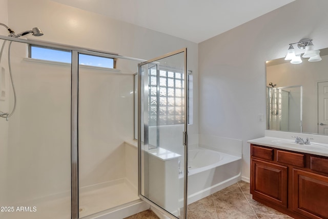 bathroom with tile patterned flooring, vanity, and separate shower and tub