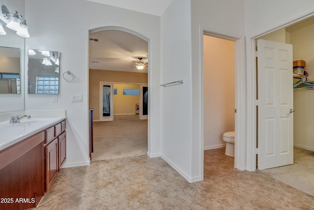 bathroom with vanity, tile patterned floors, ceiling fan, and toilet