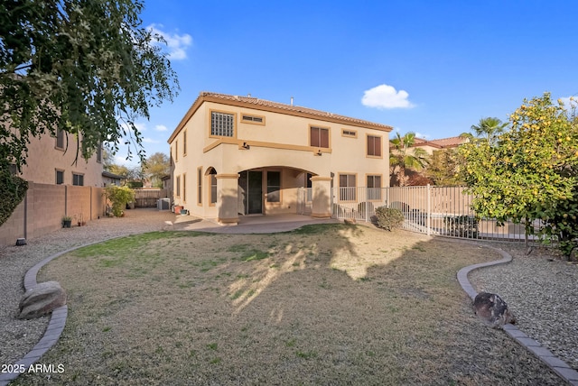 rear view of property featuring a patio