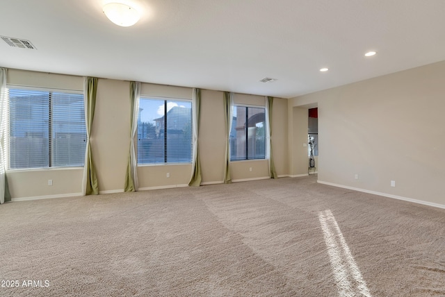 spare room with light colored carpet