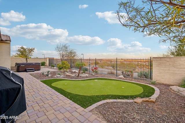 view of yard with a patio area and a hot tub