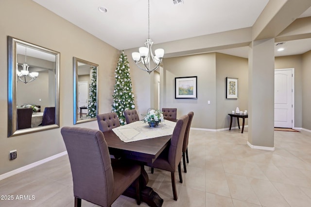 tiled dining space featuring a chandelier