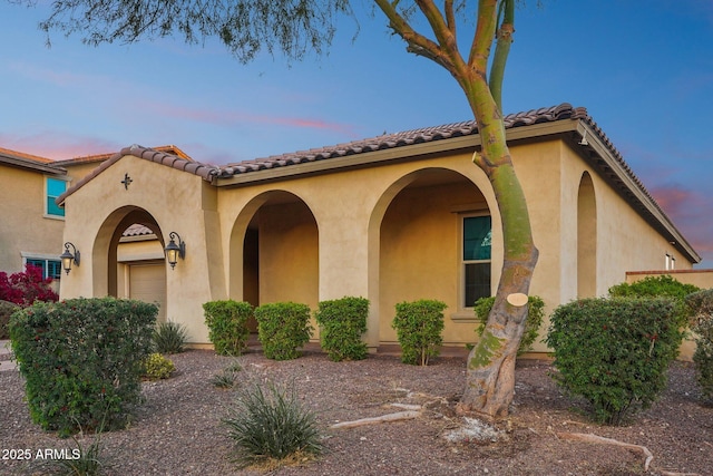 mediterranean / spanish-style home featuring a garage