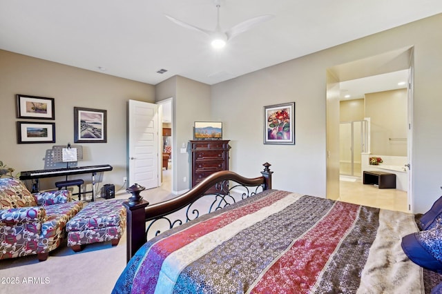 carpeted bedroom with ensuite bathroom and ceiling fan