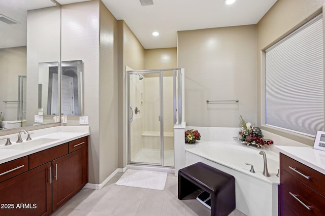 bathroom featuring tile patterned floors, vanity, and shower with separate bathtub