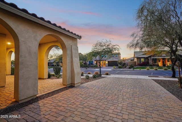 patio terrace at dusk with a garage