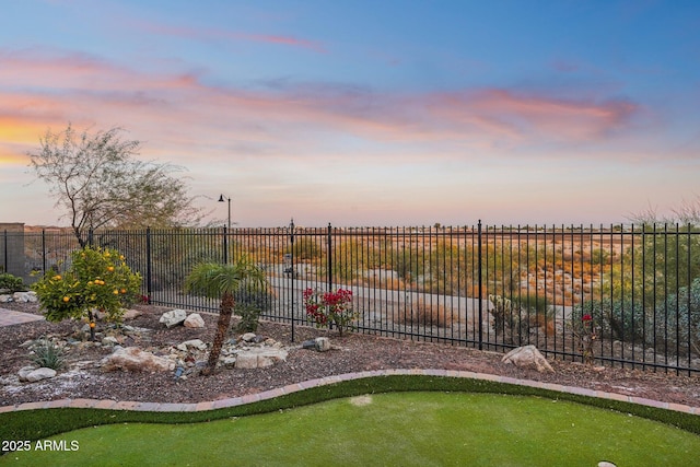 view of yard at dusk