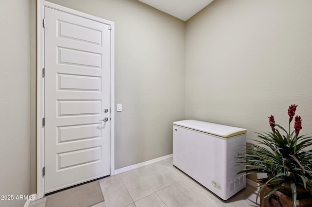 clothes washing area featuring light tile patterned floors