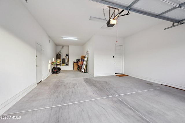 garage featuring a garage door opener and water heater