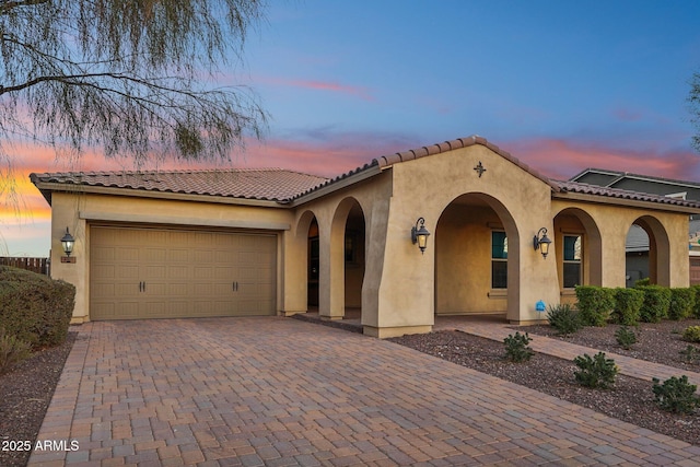 mediterranean / spanish-style home featuring a garage