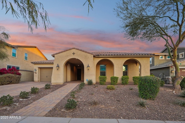 mediterranean / spanish-style home featuring a garage