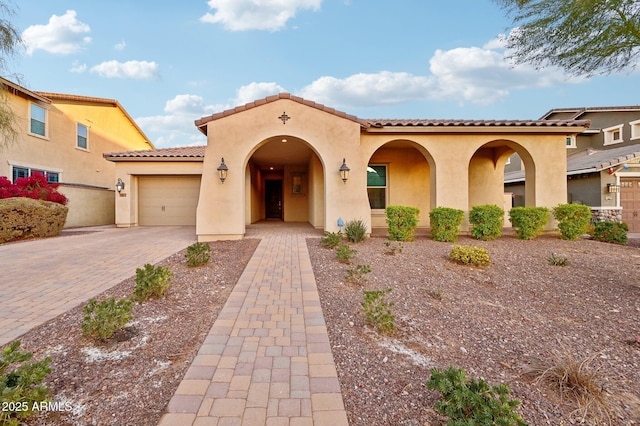 mediterranean / spanish-style home with a garage