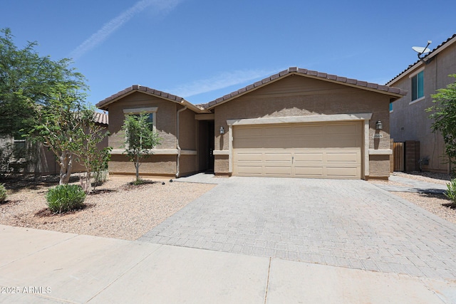 7648 W Kerby Ave, Phoenix, AZ 85043 - single story home with a tile roof, decorative driveway, an attached garage, and stucco siding