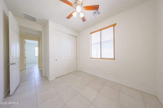 7648 W Kerby Ave, Phoenix, AZ 85043 - unfurnished bedroom featuring a closet, ceiling fan, baseboards, and light tile patterned flooring