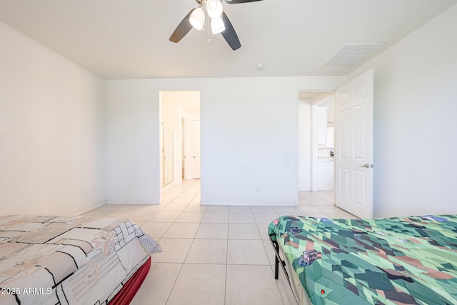 7648 W Kerby Ave, Phoenix, AZ 85043 - bedroom with light tile patterned floors, a ceiling fan, and baseboards