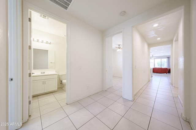7648 W Kerby Ave, Phoenix, AZ 85043 - corridor featuring light tile patterned floors, recessed lighting, and a sink