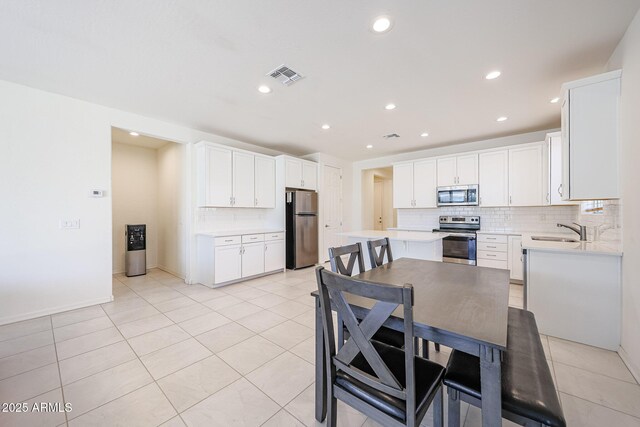 7648 W Kerby Ave, Phoenix, AZ 85043 - dining room featuring light tile patterned flooring, recessed lighting, and baseboards