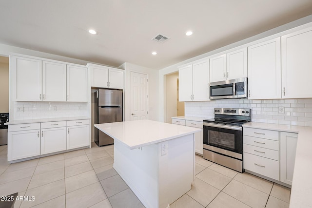 7648 W Kerby Ave, Phoenix, AZ 85043 - kitchen featuring appliances with stainless steel finishes, decorative backsplash, light countertops, white cabinetry, and a kitchen island